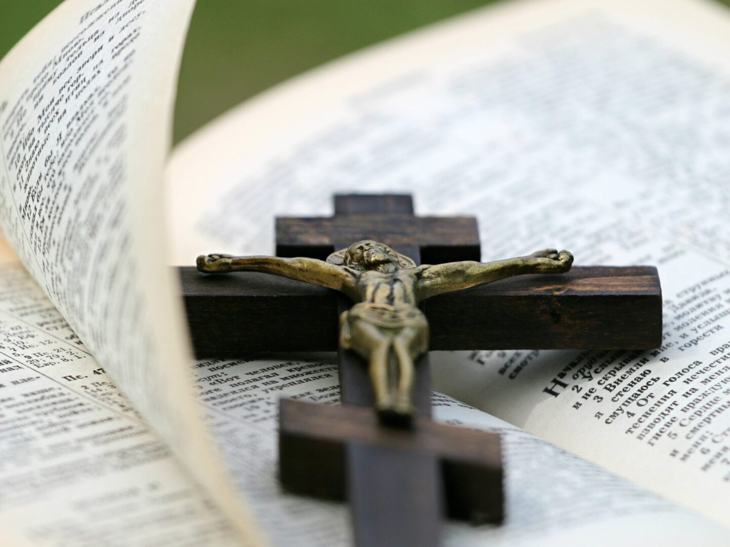 A cross on top of an open bible.