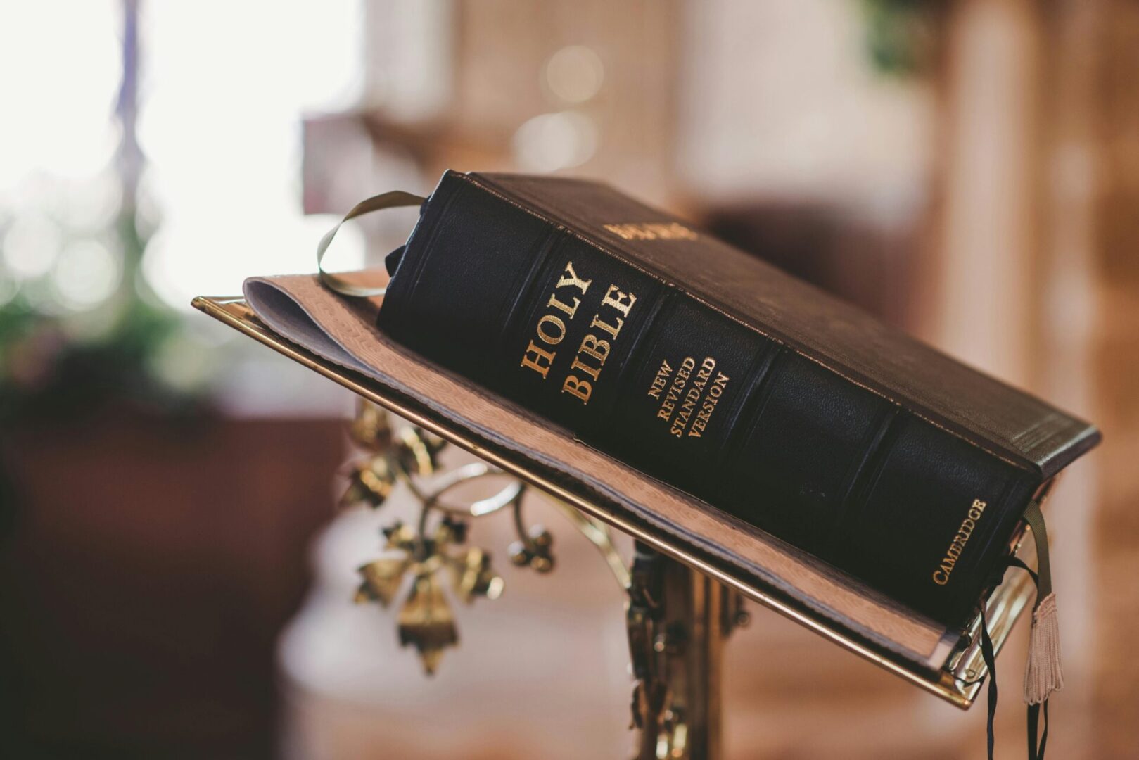 A bible is sitting on top of a stand.